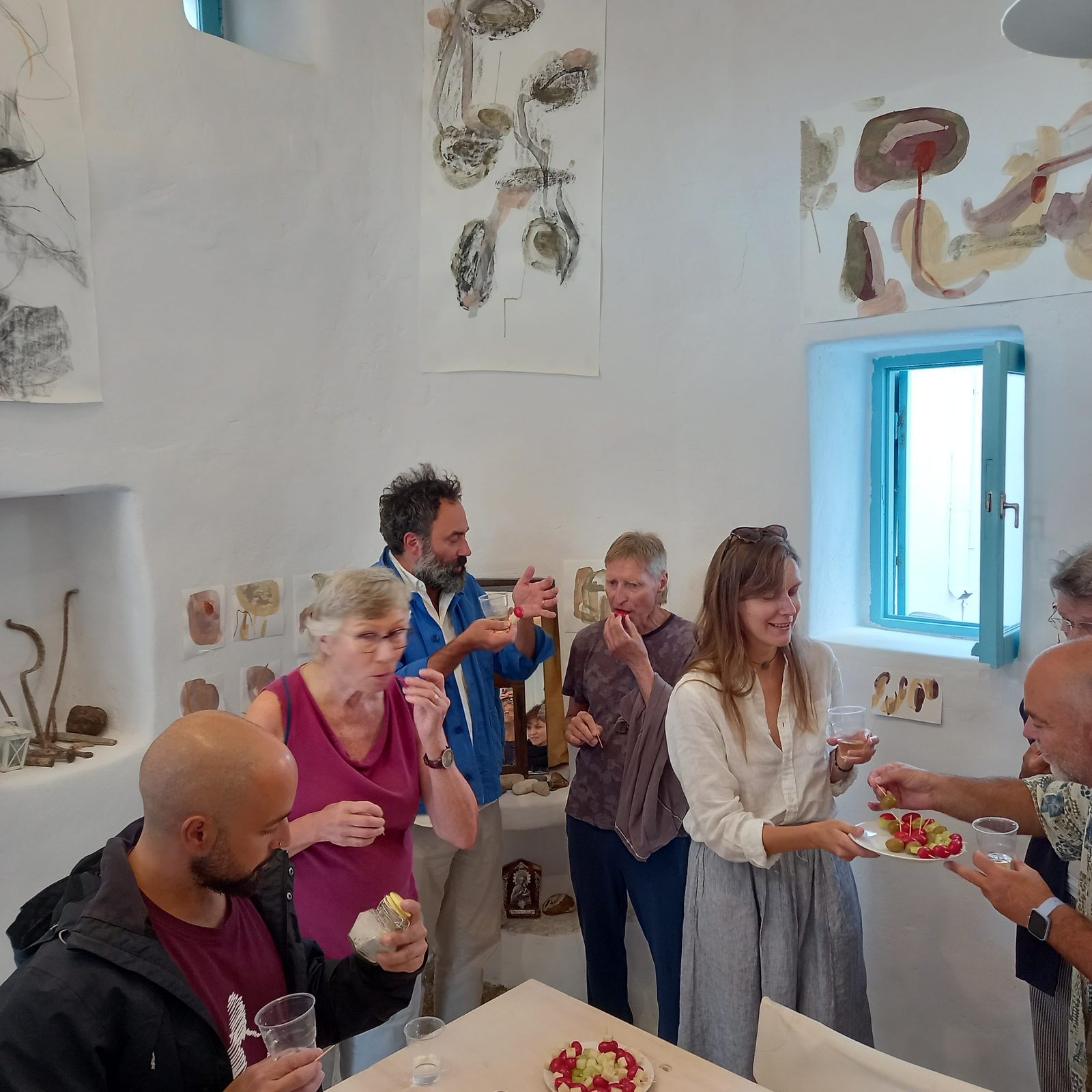 Visitors gathered in the studio among the drawings during the open studio